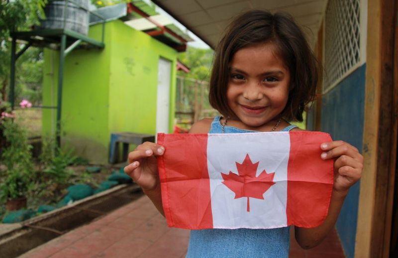 Canada Day girl holding Canadian flag